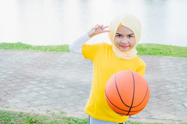 Kid,Female,In,Hijab,Play,Basketball,In,Park